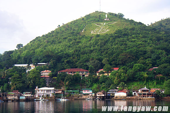 The town of Culion with its spread eagle emblem carved on a hill face