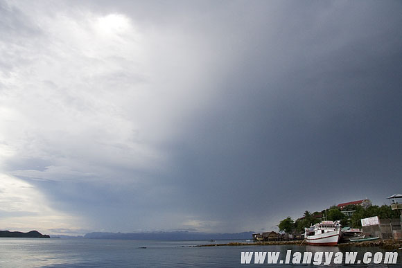 View of the sea early in the morning. The elevated promontory at the lower right shows the roof the church.