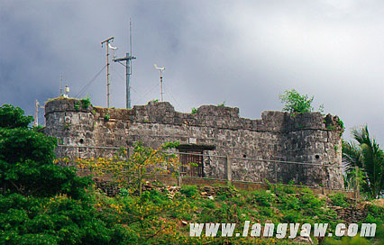 A small fort, one of two, stands guard high above a hill in Romblon, Romblon overlookin the sea and the town below.