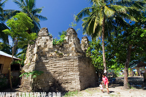 A crumbling baluarte at the corner of a once fortified settlement in Oslob, Cebu. The current state is so poor with overgrown vegetation further weakening the stones.