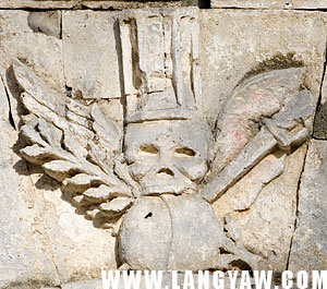 Skull with wings and other symbols at the top of the mortuary chapel entrance in Argao
