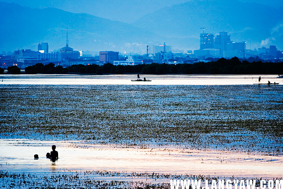 A stunning view of Cebu at dusk as the city makes an urban backdrop and images of the simple and carefree life is in the foreground. 