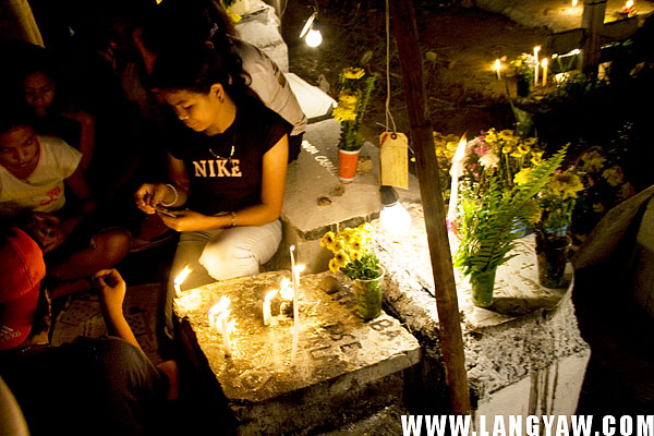 Whiling away time at the cemetery by playing rounds of card games.