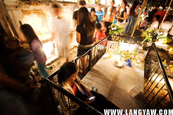 A lady with her dead fenced from the outside. It's her small private space where time is whiled away with SMS.