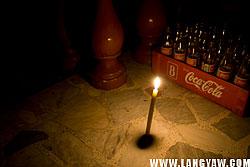 A candle is lighted near the door of houses in Talisay City.