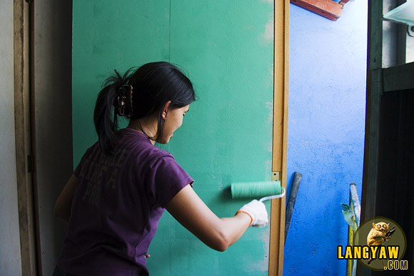 A volunteer putting a paint finish at a Gawad Kalinga project site in North Metro Manila