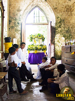 Sacristans waiting for the start of the Good Friday procession in Sibonga