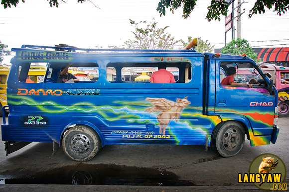 A flying pig decorates the body of another jeepney