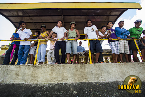 Men gather at the waiting shed to ogle at our party, a group of bloggers and our host.