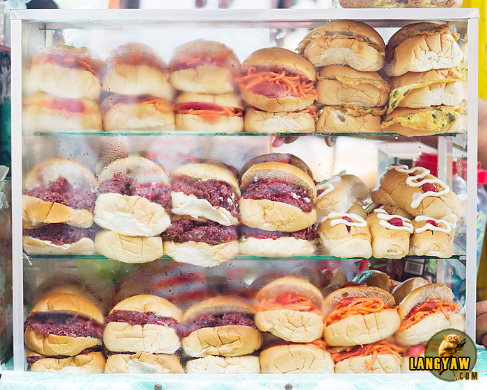 Burger buns with different and unusual fillings: biko (sticky rice cake), spaghetti, scrambled eggs, bihon (rice noodles)