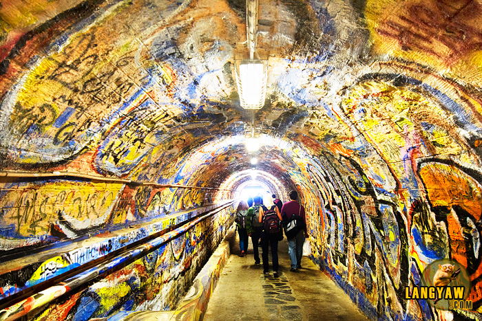 Colorful graffiti has taken over all the surface of the tunnel walls