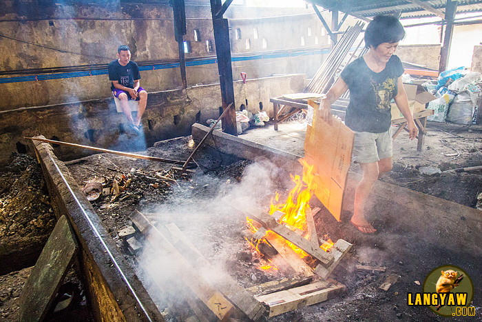 The spit is then stacked with wood and lit. 