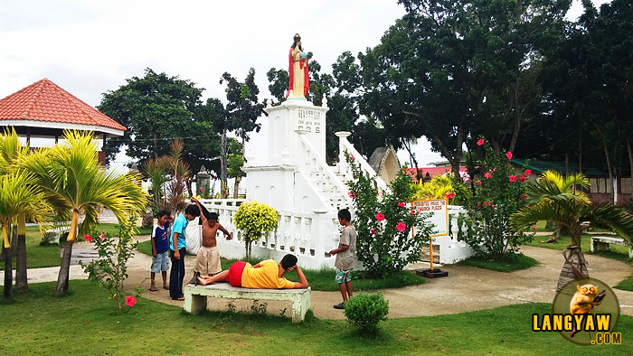 Group of boys playing near the Cristo Rey monument facing the facade of the church