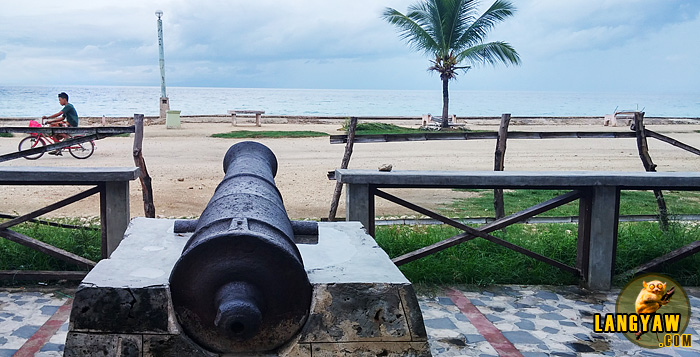 Cannon facing the sea that is mounted infront of a century old watchtower