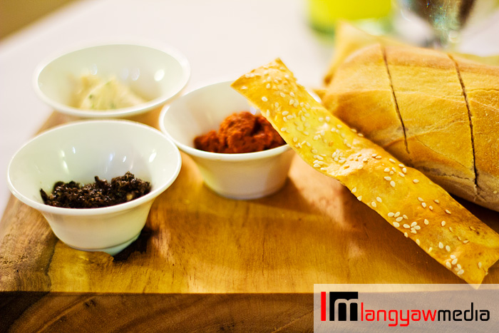 Ciabatta bread and lavoush (long bread stick) with different spreads: sun dried tomato, black olive tapenade and chicken coriander spread