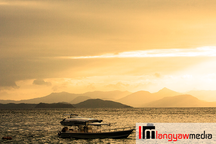 Sunset at Flower Islan with a view of the rugged terrain of northern Palawan