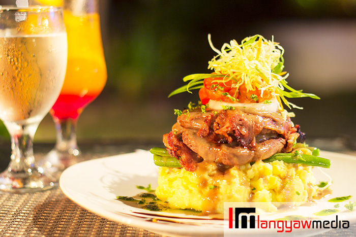 Island style fillet mignon: fillet mignon wrapped with bacon on a bed of mashed potatoes 