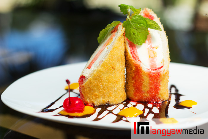 Vanilla melt tempura: this fried ice cream has  sliced mango and puree plus ice cream inside topped with mint leaves and drizzled with chocolate syrup and cherry