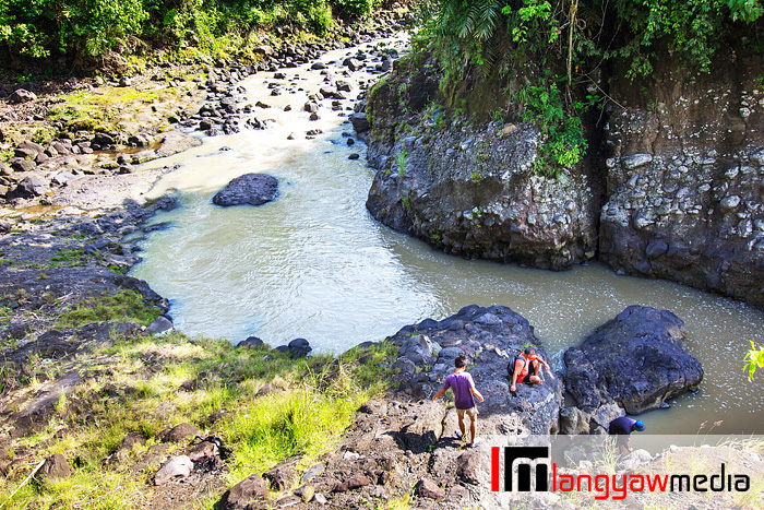 Men preparing to fish at the river along the route to the waterfall