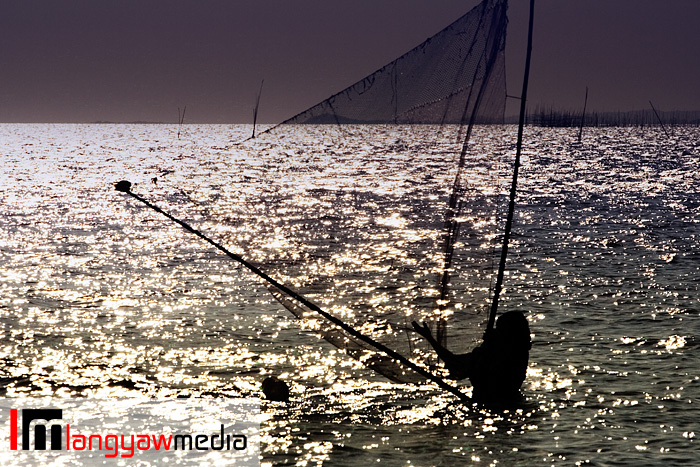 Shrimp trawling in the shallow coast of Valladolid in Negros occidental before the sun sets