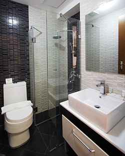 The unit's contemporary toilet and bath