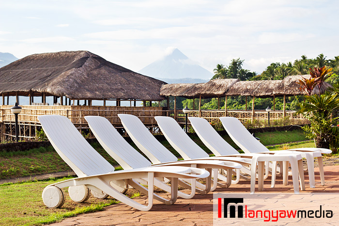Pool lounge chairs with Mt. Mayon in the background