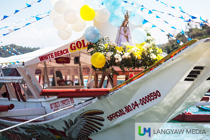 The image of the Our Lady of Fatima leads the fluvial procession along Puerto Galera Bay