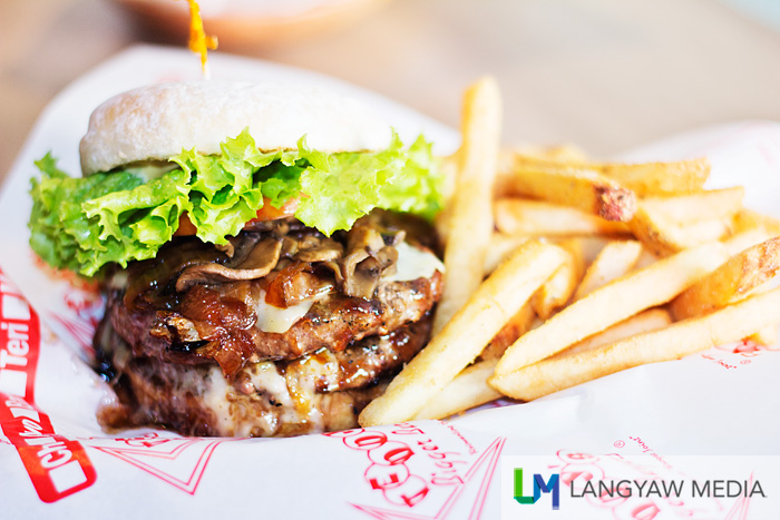 This is a monster, a delicious monster! Kailua Monster Double Big Burger: double 5 oz. patties, topped with grilled mushrooms, grilled onions, swiss cheese and teri sauce with garlic flavored thick fries on the side