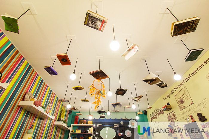 Books, punctured, screwed and hung at the ceiling