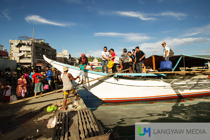 Despite everything, life just goes on. Passengers from another off sea barangay arrives in Tacloban