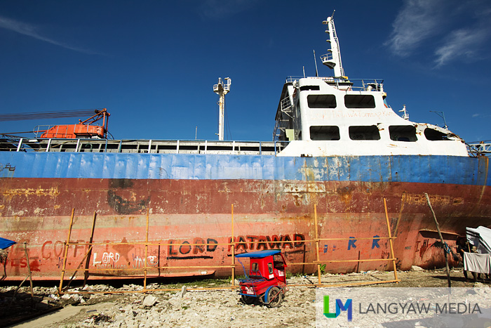 A tricycle parked beside the ship