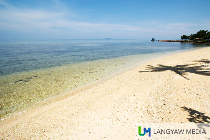 Private beach with its white beach strip