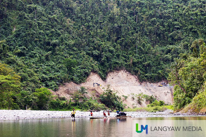 Other children transporting goods up river