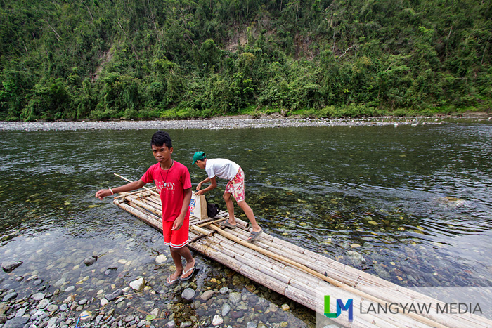 During school breaks and weekends, these children support their families by transporting people and goods up and down the Timbaban River through bamboo rafts like this one