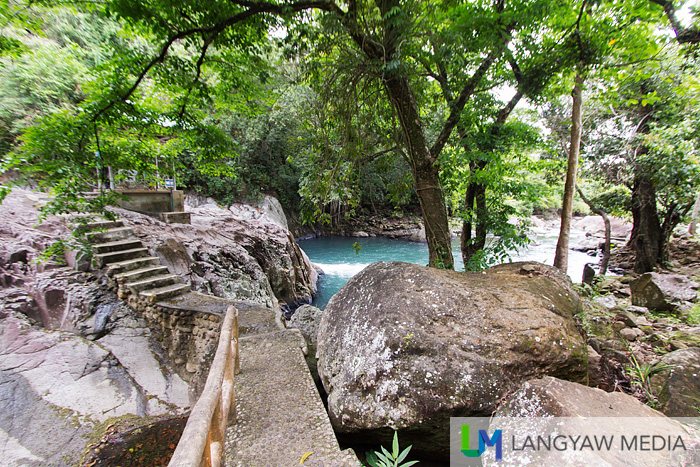 cemented path with railing that leads you to the waterfall