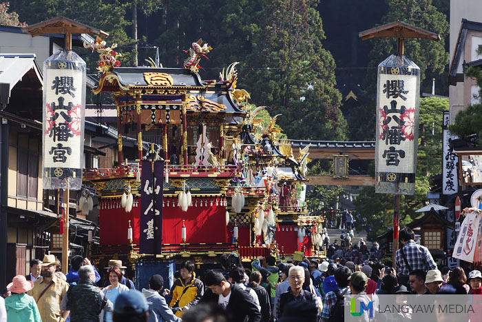 The lineup of ten yatai as seen from the far end of the road leading to the shrine