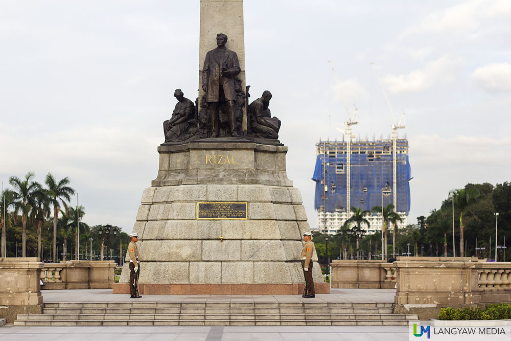 Rizal Monument with the controversial DMCI building