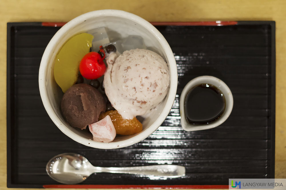 Ogura Anmitsu, a traditional Japanese dessert containing sweet red bean paste, agar jelly, boiled beans, gyuhi (soft sweets made from glutinous rice flour) and fruits. It is eaten with raw sugar syrup.