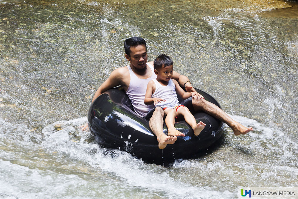 A fun way to enjoy Bantimurung Waterfalls is riding the water through this inflated tire tube