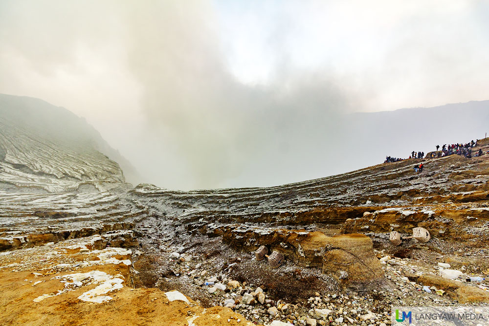 A portion of the crater at Kawah Ijen as volcanic smoke emanates from below